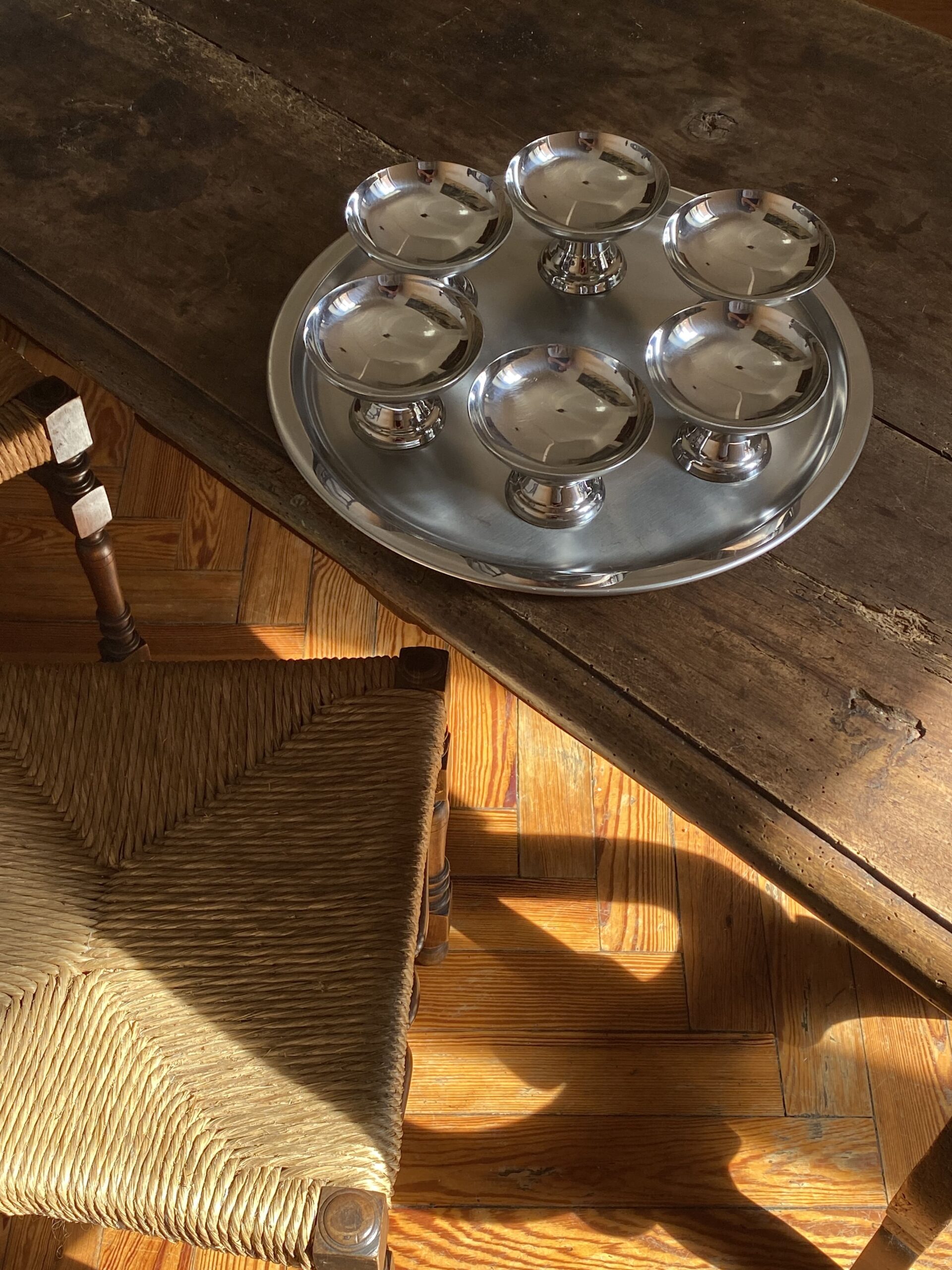 A serene tableau featuring a sculptural vintage espresso set with a classic Italian moka pot and collectible espresso cups, thoughtfully arranged on a polished wooden refined breakfast tray. Bathed in soft, natural morning light, this scene perfectly evokes a quiet Italian mornings ritual, emblematic of quiet luxury home decor.