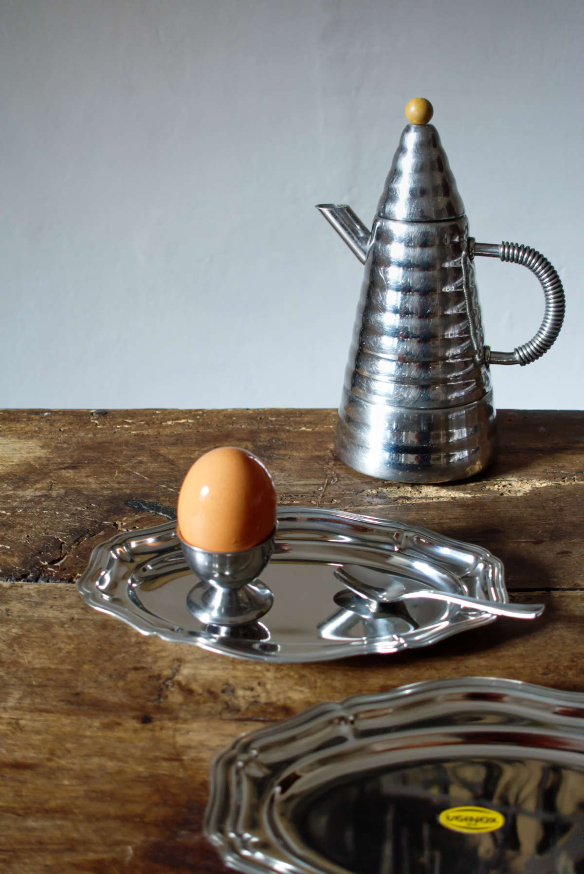 A beautifully styled vignette of a sculptural vintage espresso set, including collectible espresso cups and a moka pot, bathed in soft morning light. This image embodies timeless Mediterranean design and is part of a morning ritual.